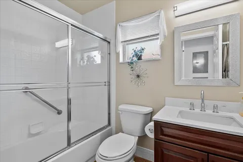 a white toilet sitting next to a bathroom sink