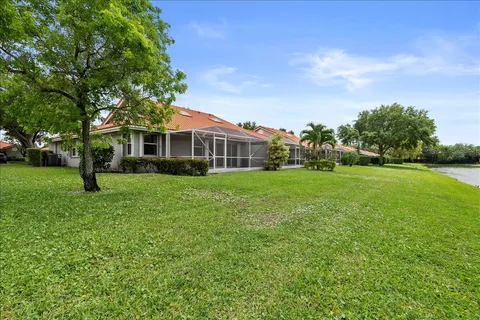 a view of a house with a backyard