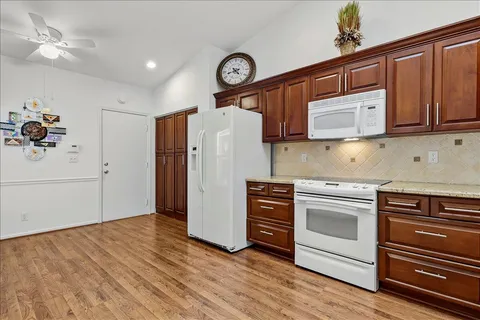 a kitchen with granite countertop a refrigerator and a stove
