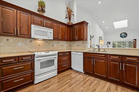 a kitchen with wooden cabinets and stainless steel appliances