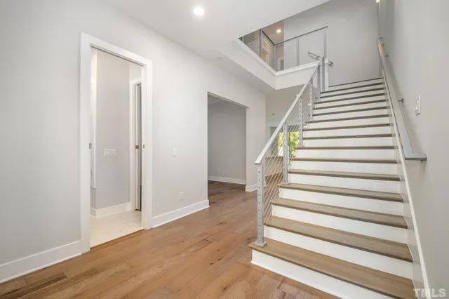 a view of entryway and hall with wooden floor