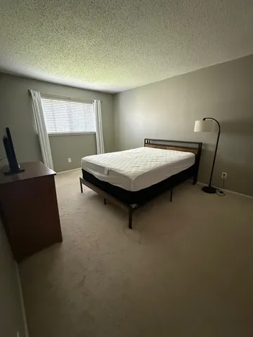 a bedroom with a bed and window