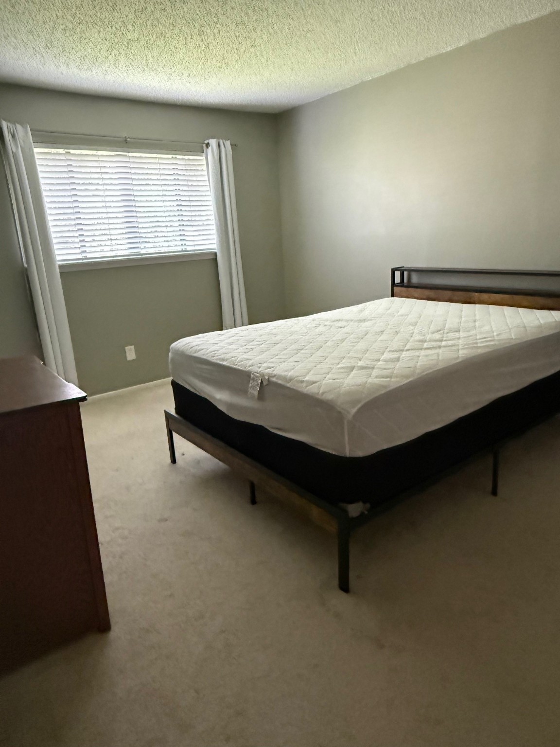 7112 North Holiday Drive, Unit 7112 Galveston, TX 77550 - Photo 16 of 19 a bed sitting in a room next to a window