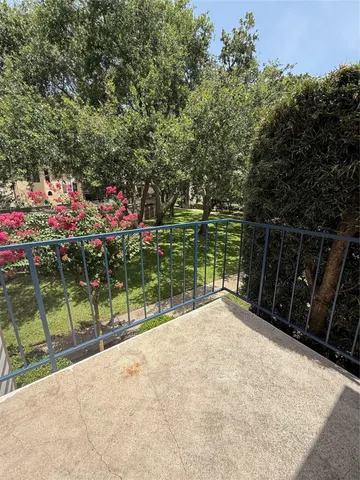a view of a pathway with a wrought fence