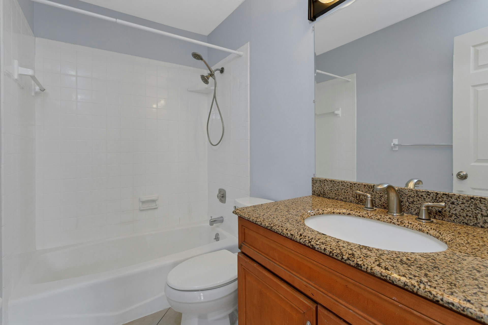 52 Randall Avenue, Unit 8 Stamford, CT 06905 - Photo 12 of 24 a bathroom with a granite countertop sink toilet and shower