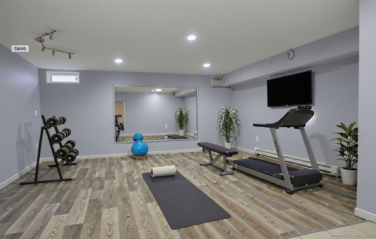 52 Randall Avenue, Unit 8 Stamford, CT 06905 - Photo 14 of 24 a living room with furniture and a flat screen tv