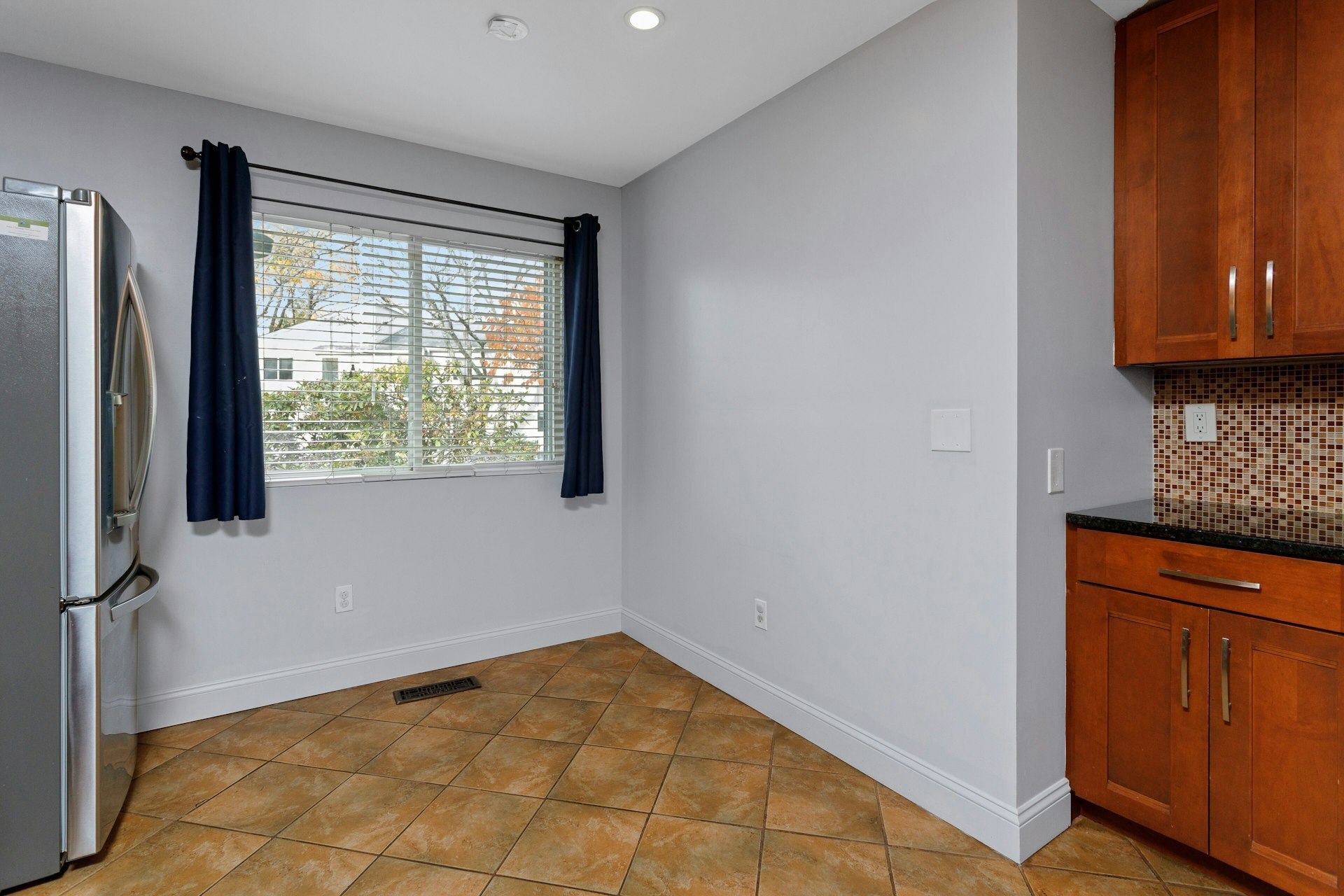 52 Randall Avenue, Unit 8 Stamford, CT 06905 - Photo 5 of 24 a view of an empty room with window and a kitchen