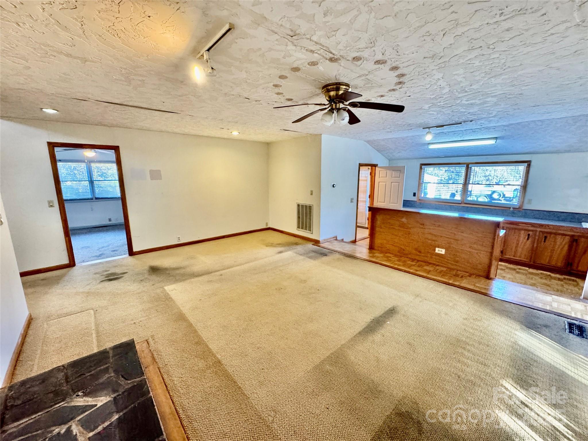 199 Bell Farm Road Statesville, NC 28625 - Photo 18 of 48 a view of a livingroom with a fireplace and a ceiling fan