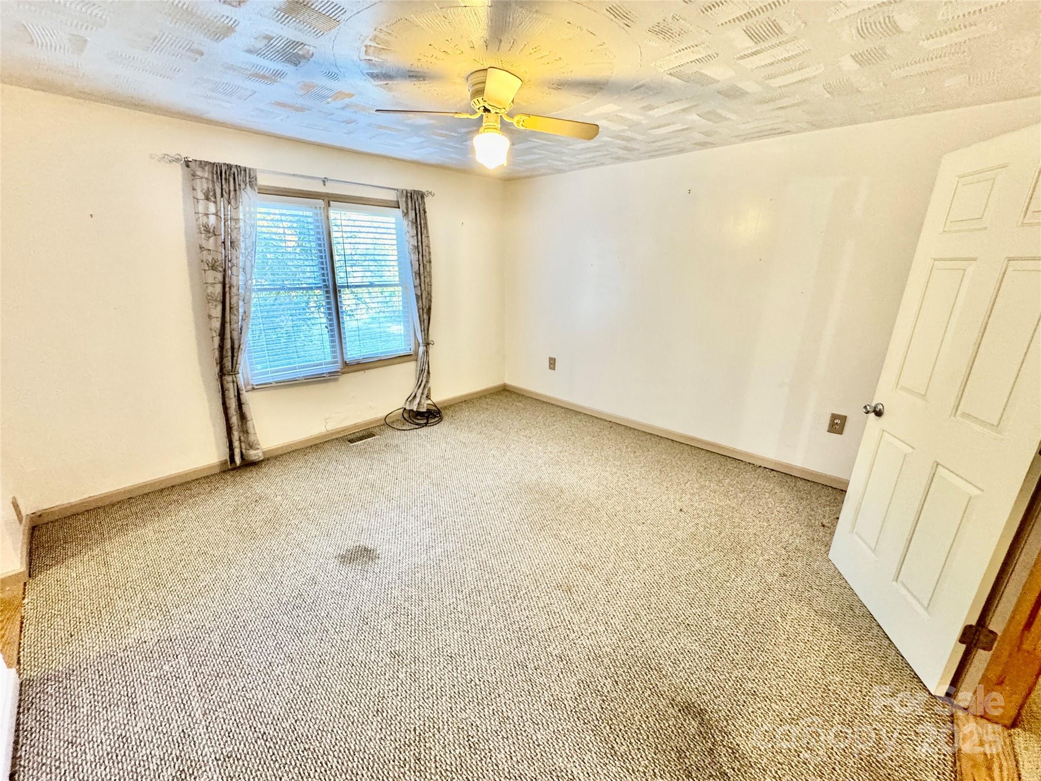 199 Bell Farm Road Statesville, NC 28625 - Photo 24 of 48 a view of an empty room with a window