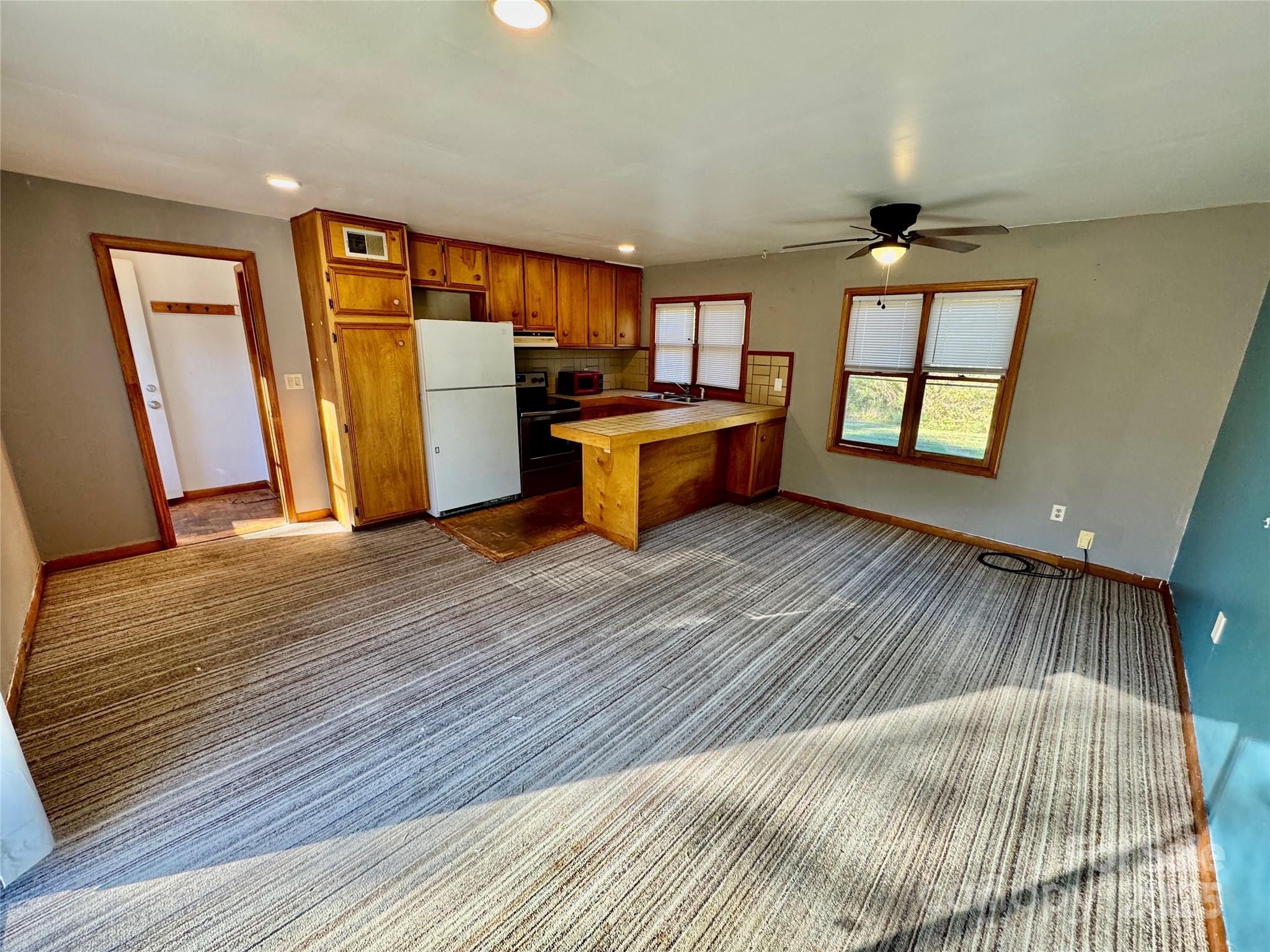 199 Bell Farm Road Statesville, NC 28625 - Photo 41 of 48 a view of a kitchen with wooden floor and a sink