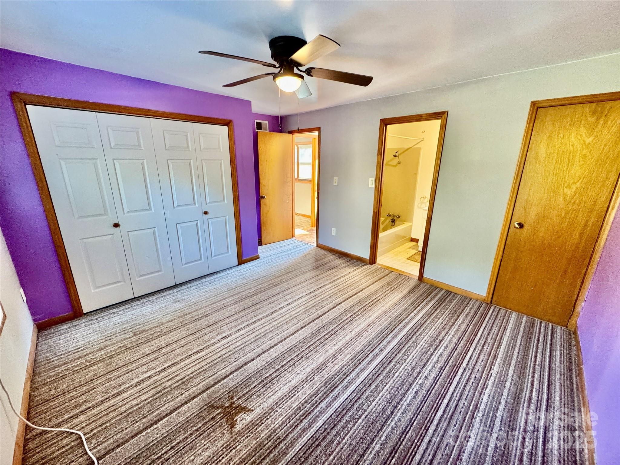 199 Bell Farm Road Statesville, NC 28625 - Photo 45 of 48 a view of an empty room with wooden floor and a ceiling fan