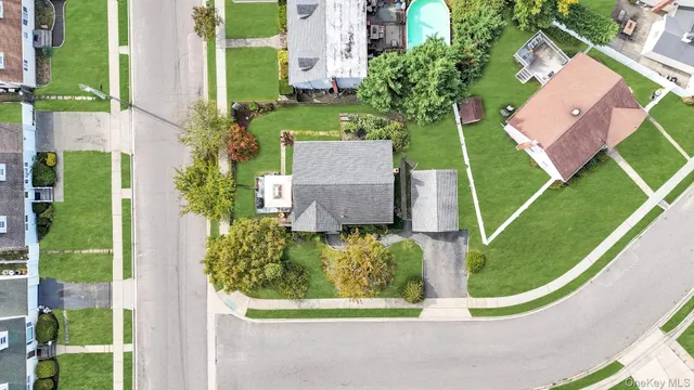 an aerial view of a house with a garden and trees