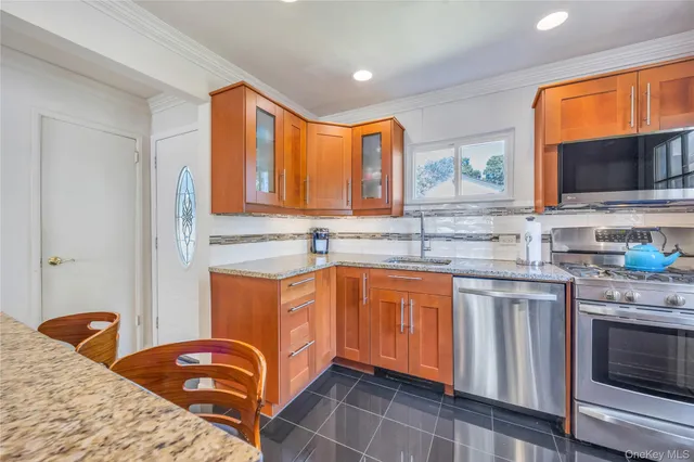 a kitchen with stainless steel appliances granite countertop a sink and cabinets