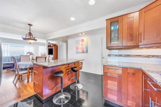 a dining room with furniture a chandelier and kitchen view
