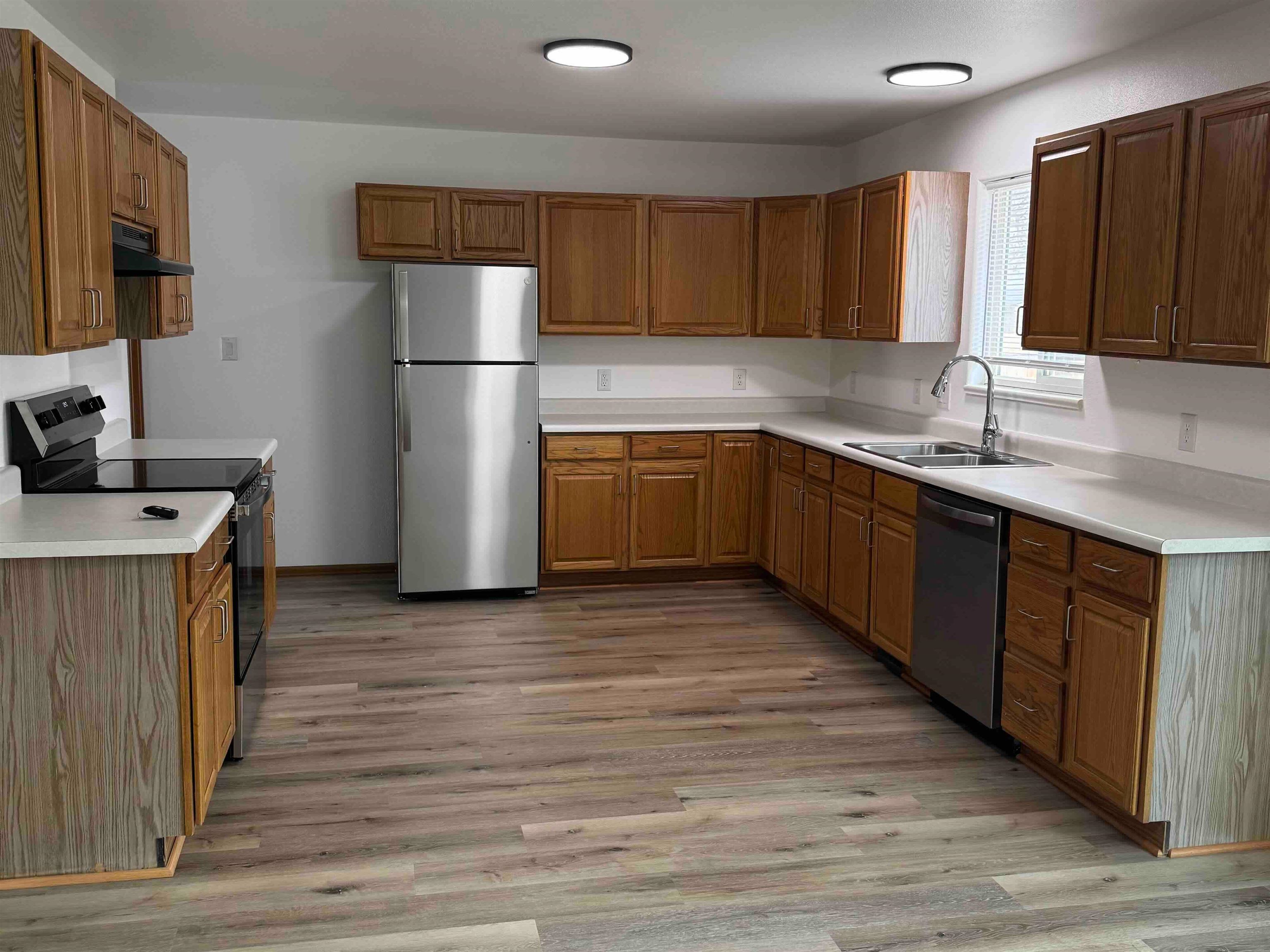 419 1/2 29 1/2 Road Grand Junction, CO 81504 - Photo 5 of 36 a kitchen with stainless steel appliances granite countertop a refrigerator a sink dishwasher a stove with wooden cabinets and floor