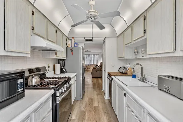 a kitchen with stainless steel appliances granite countertop a stove and a refrigerator