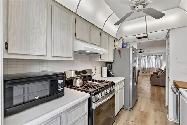 a kitchen with cabinets a sink and appliances