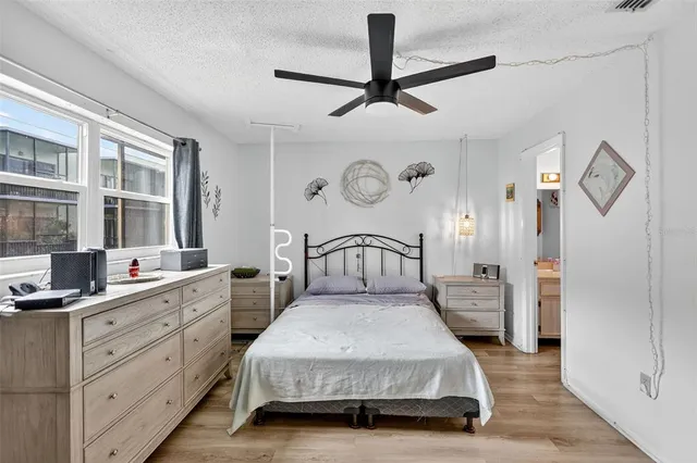 a bedroom with a bed and a large mirror