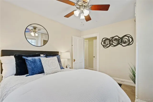 a bedroom with a bed and a potted plant