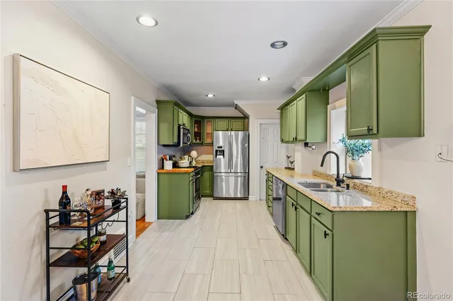 a kitchen with stainless steel appliances granite countertop a refrigerator a stove top oven a sink and dishwasher