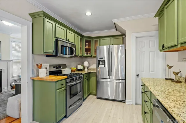 a kitchen with a sink cabinets and stainless steel appliances