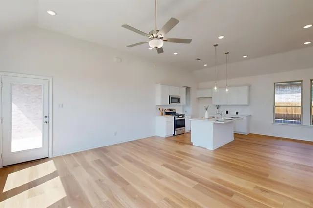 a view of a kitchen with a sink and cabinets