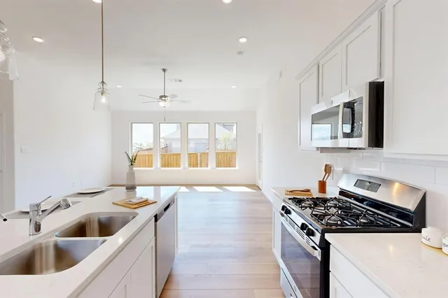 a kitchen with a stove and a sink