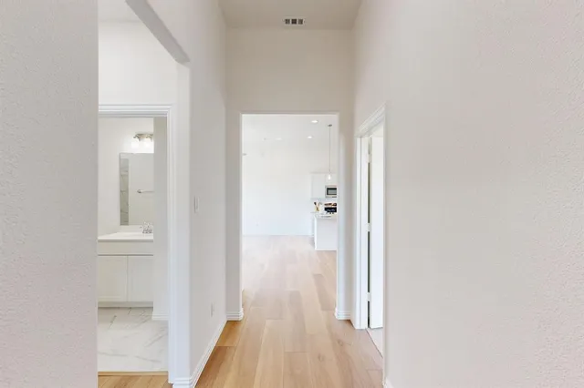 a view of a bathroom from a hallway