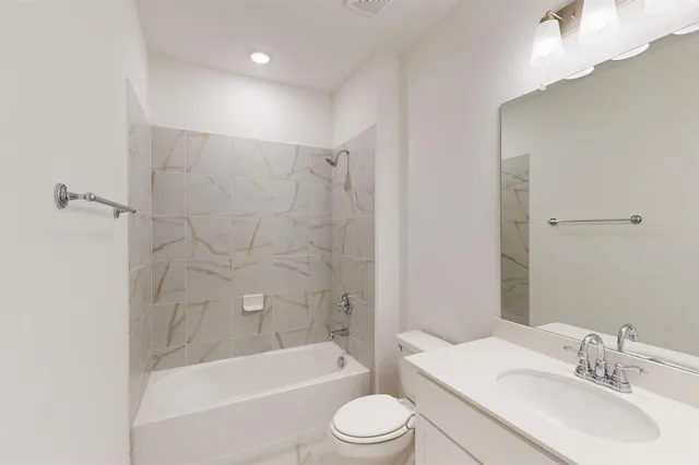 a bathroom with a sink toilet and bathtub