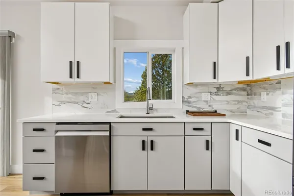 a bathroom with a toilet a sink and vanity