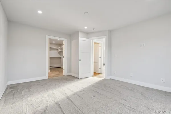 a view of a balcony with a floor to ceiling window and wooden fence