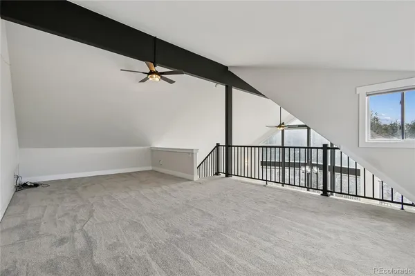a view of empty room with wooden floor and fireplace