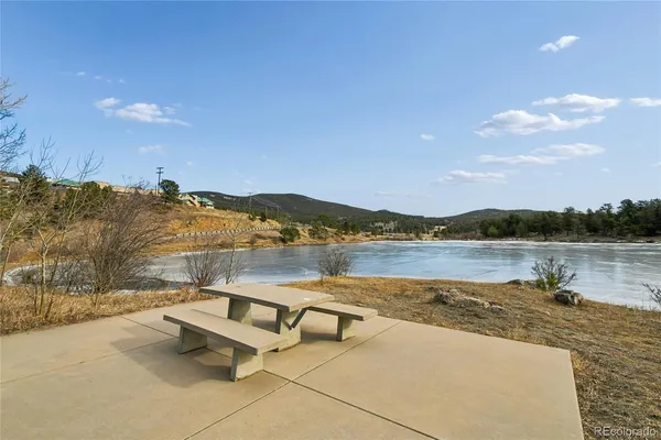 a balcony with wooden floor and lake view
