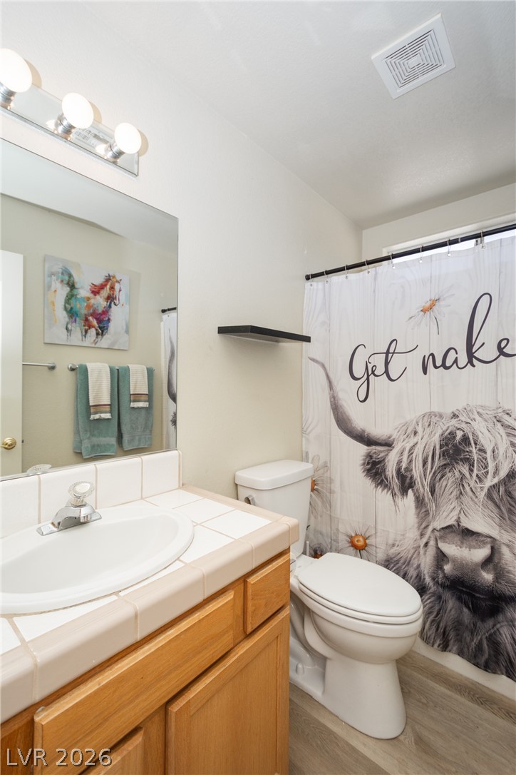 2381 Tough Boy Road Pahrump, NV 89060 - Photo 25 of 44 This bright bathroom offers a clean vanity with tiled counters and modern fixtures.