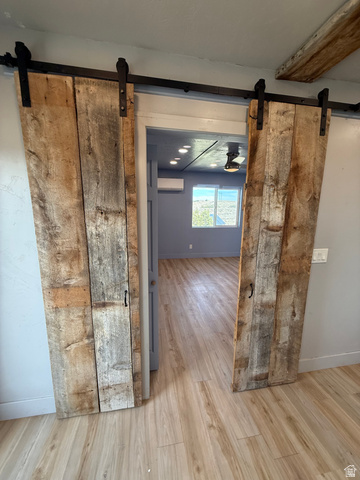14183 High Mesa Loop Duchesne, UT 84021 - Photo 37 of 56 Hall featuring a barn door and light wood-style flooring