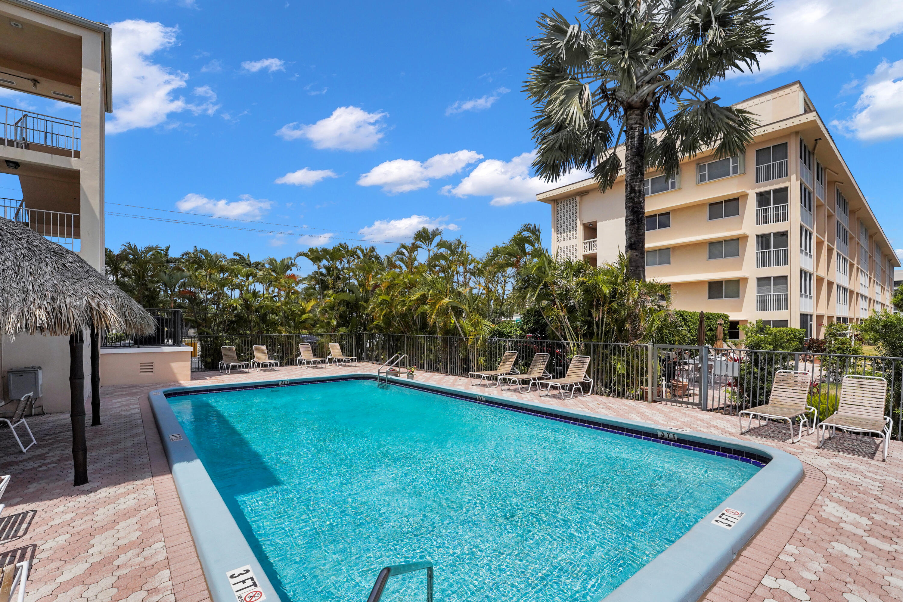 750 Northeast Spanish River Boulevard, Unit 1020 Boca Raton, FL 33431 - Photo 41 of 43 a view of a swimming pool with a patio