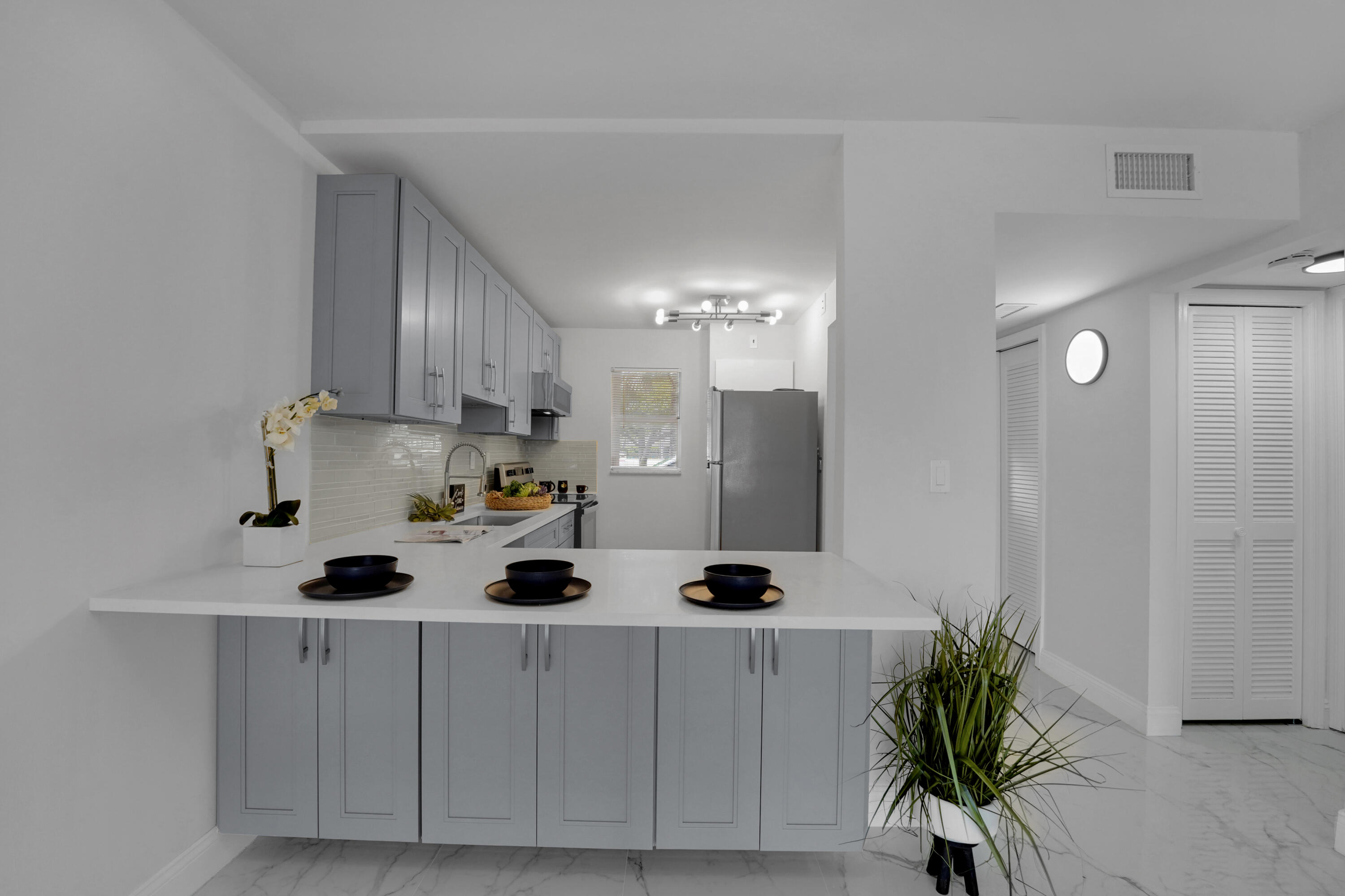 750 Northeast Spanish River Boulevard, Unit 1020 Boca Raton, FL 33431 - Photo 10 of 43 a kitchen with stainless steel appliances a refrigerator a sink a stove and cabinets