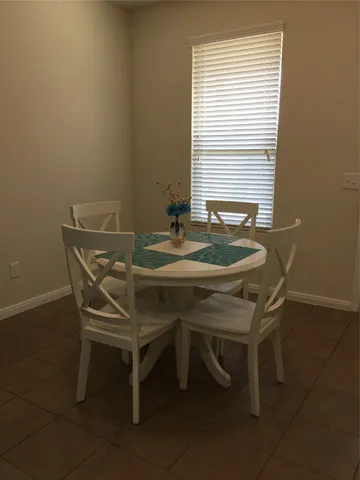 a dining room with furniture and window