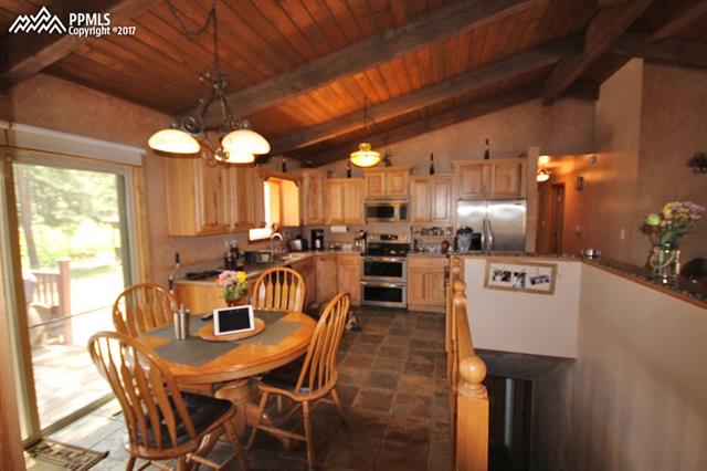 3415 Arena Road Colorado Springs, CO 80921 - Photo 7 of 36 Kitchen Eating Area with Walk-Out to Deck