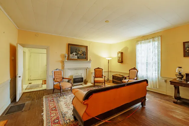a living room with furniture rug and wooden floor
