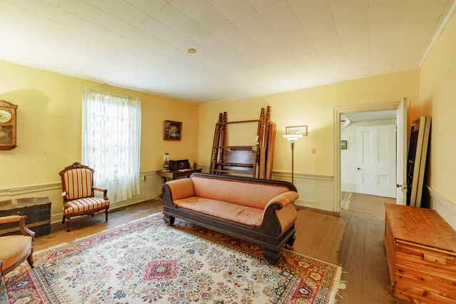 a living room with furniture rug and a table