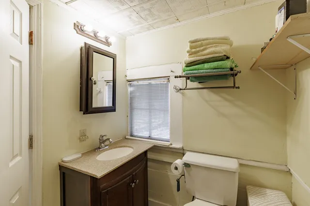 a bathroom with a sink a toilet and mirror