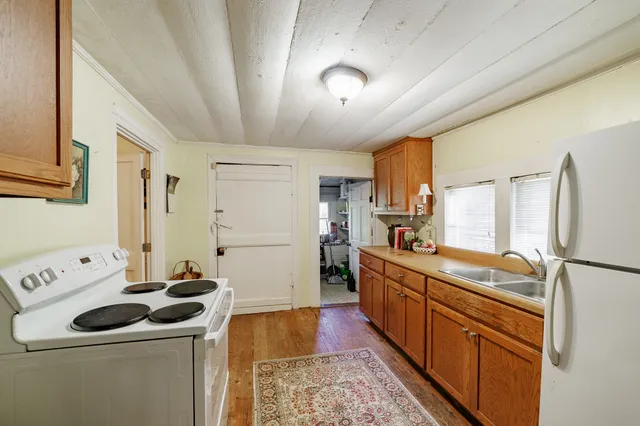 a kitchen with a sink stove and refrigerator