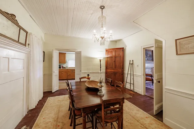 a view of a dining room with furniture and chandelier