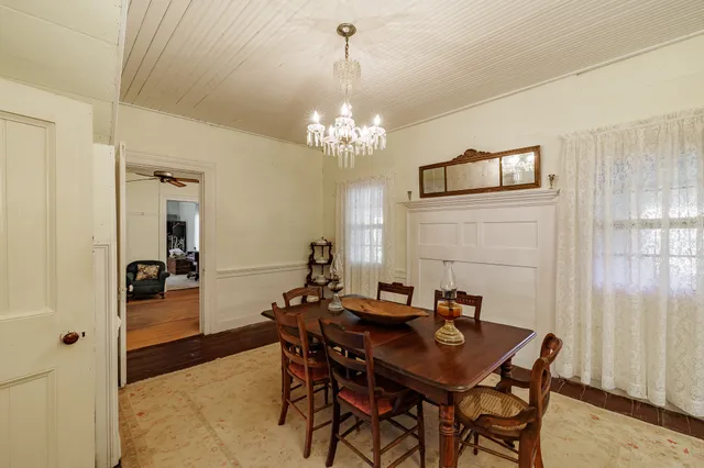 a view of a dining room with furniture and chandelier