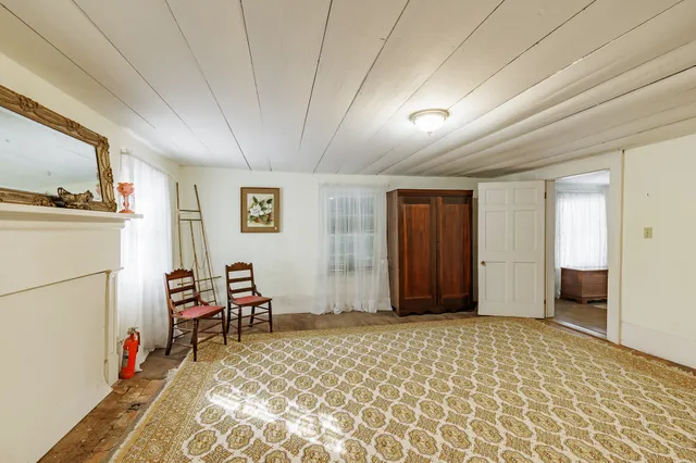 a view of a livingroom with furniture and a hallway