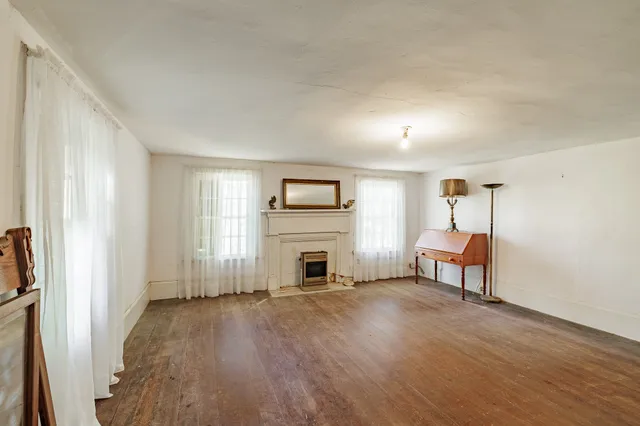 a view of a livingroom with furniture wooden floor and a window