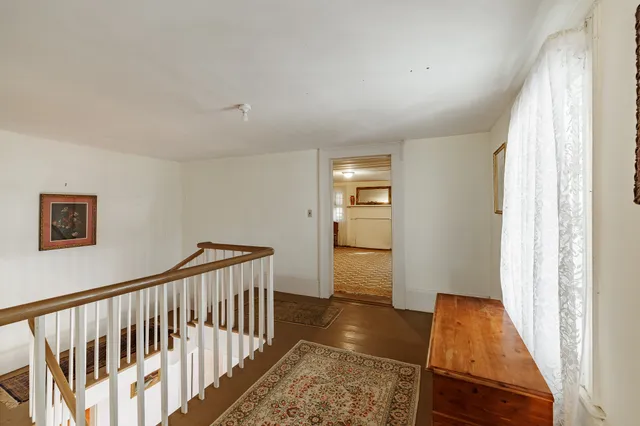 a view of hallway with wooden floor