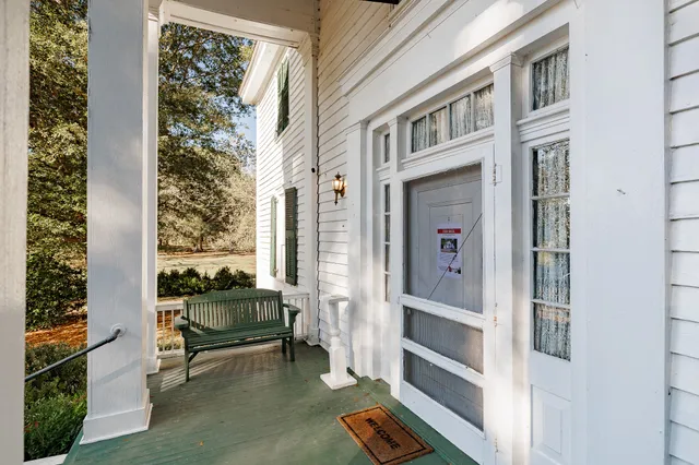 a view of a balcony with table and chairs