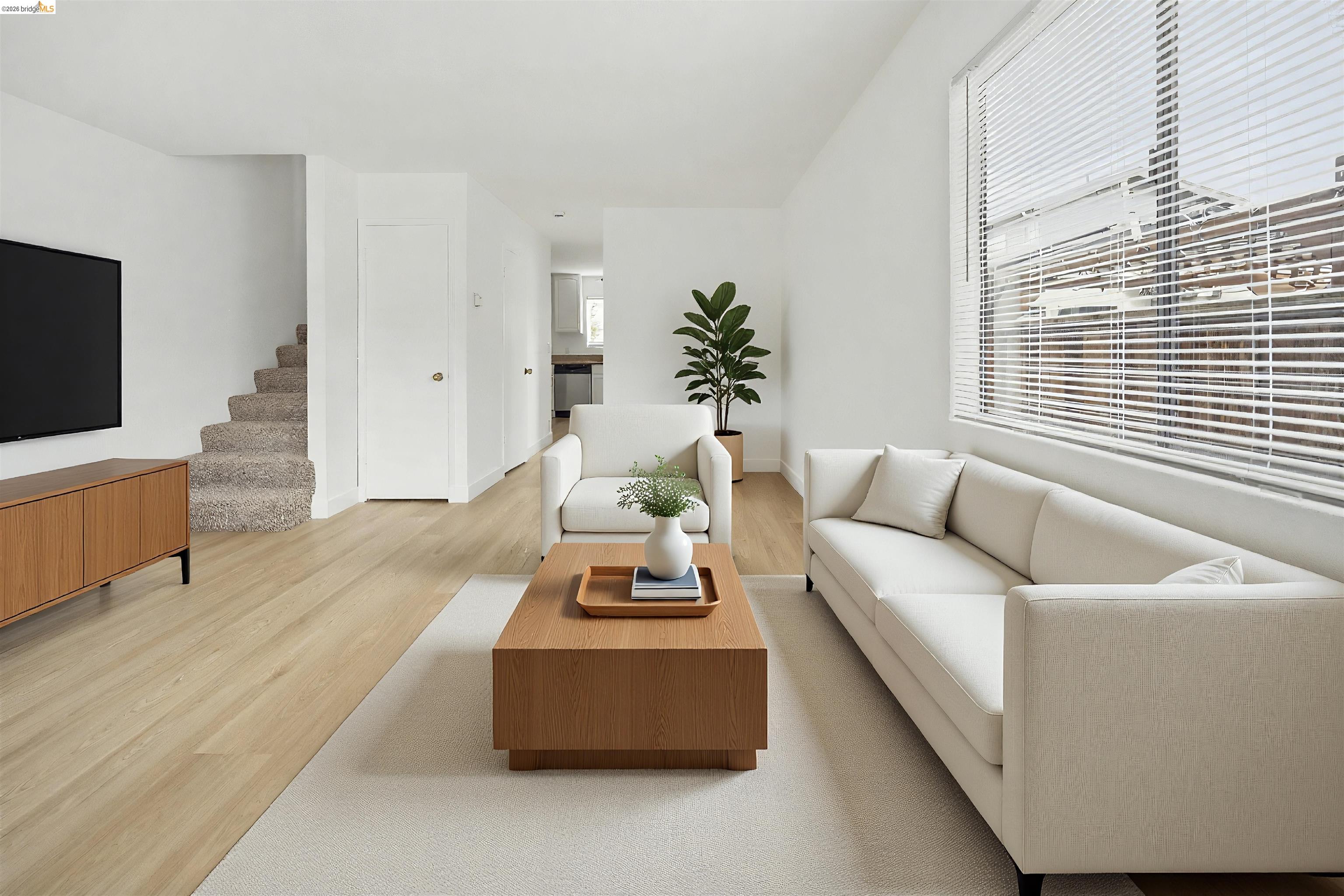 10933 Julius Street, Unit D Oakland, CA 94605 - Photo 1 of 28 a living room with furniture and a flat screen tv